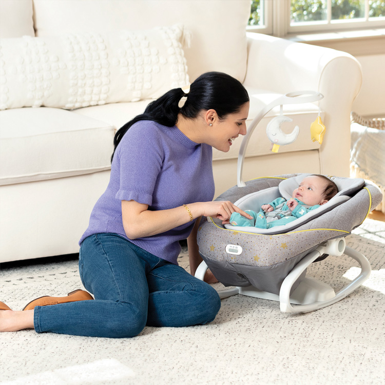 Mum playing with baby relaxing in Graco All Ways Soother