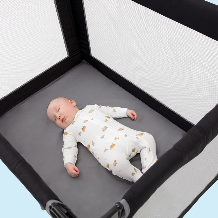 Baby sleeping in Graco Compact travel cot