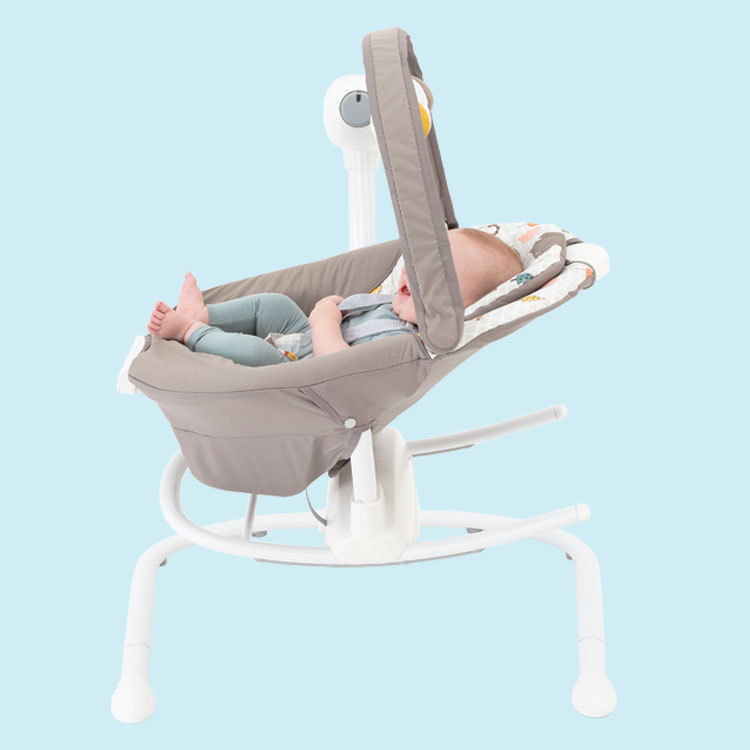 Baby sitting in Graco Duet Sway multi-direction seat on blue background. 