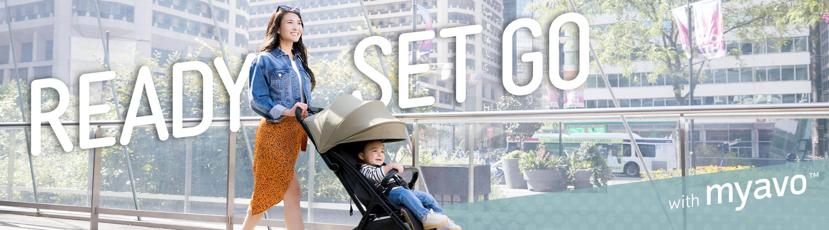 Mum and baby walking through the city in Graco Myavo with Ready, Set, Go text. 